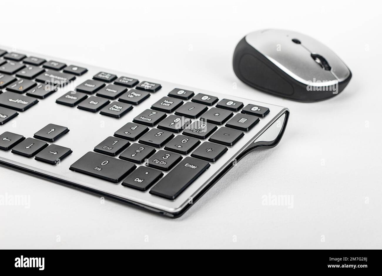 Keyboard and computer mouse of black and silver colors. Modern input
