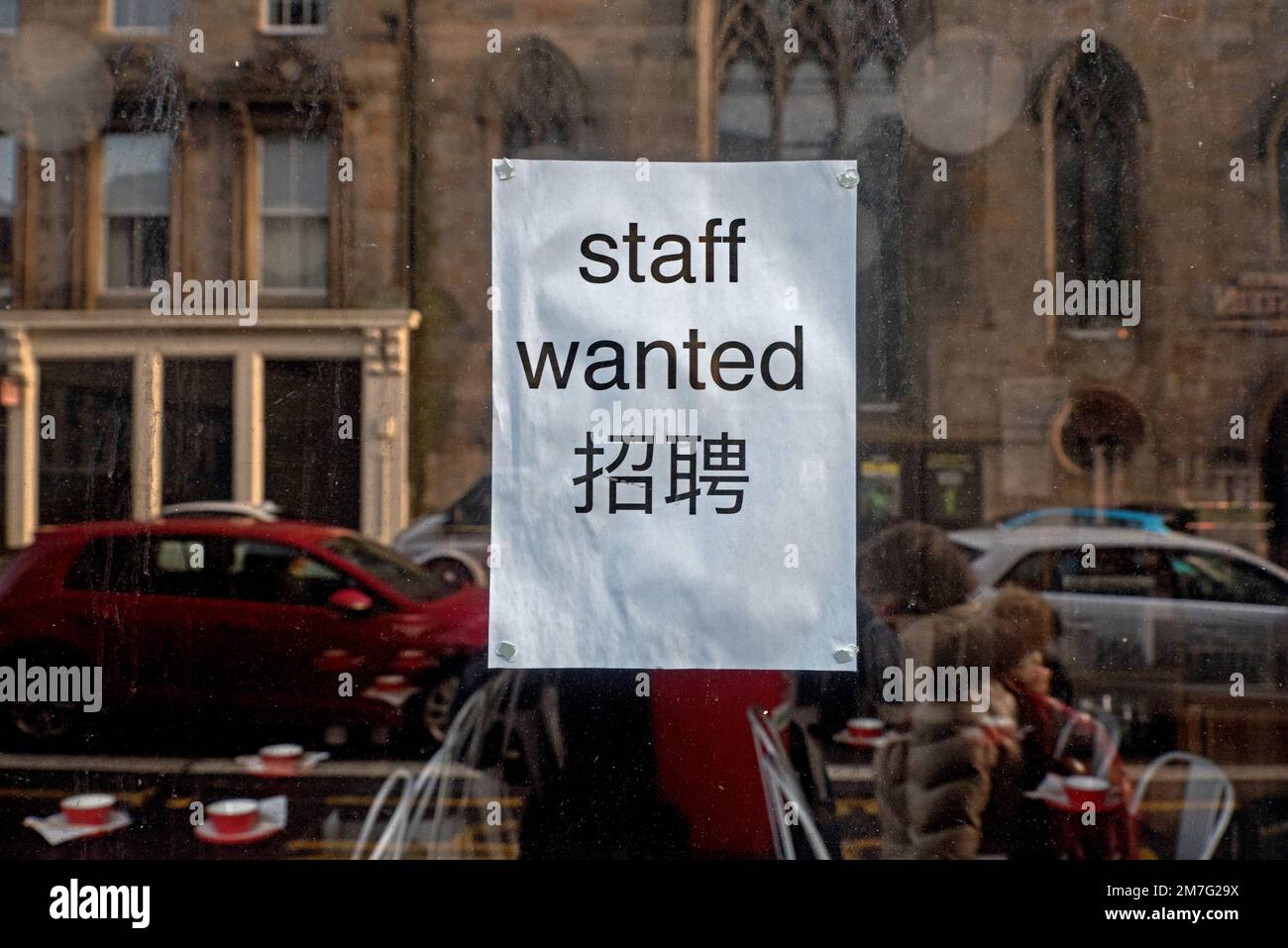 Staff Wanted, notice in English and Chinese in the window of a chinese restaurant in Edinburgh, Scotland, UK. Stock Photo