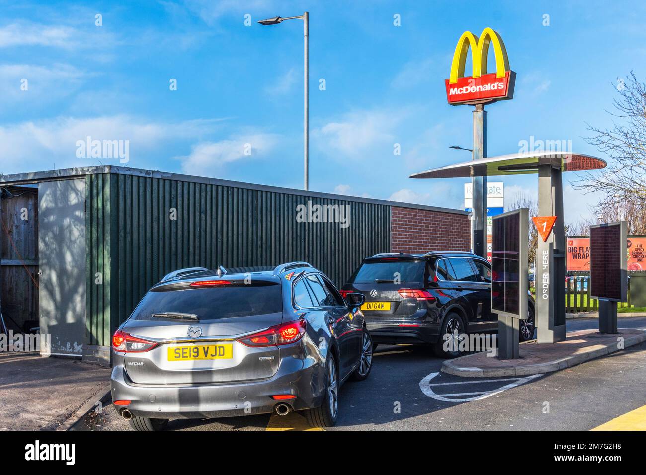 Cars in queue for  the ordering point at the drive thru for the McDonalds fast food outlet, Irvine, Ayrshire, Scotland, UK Stock Photo