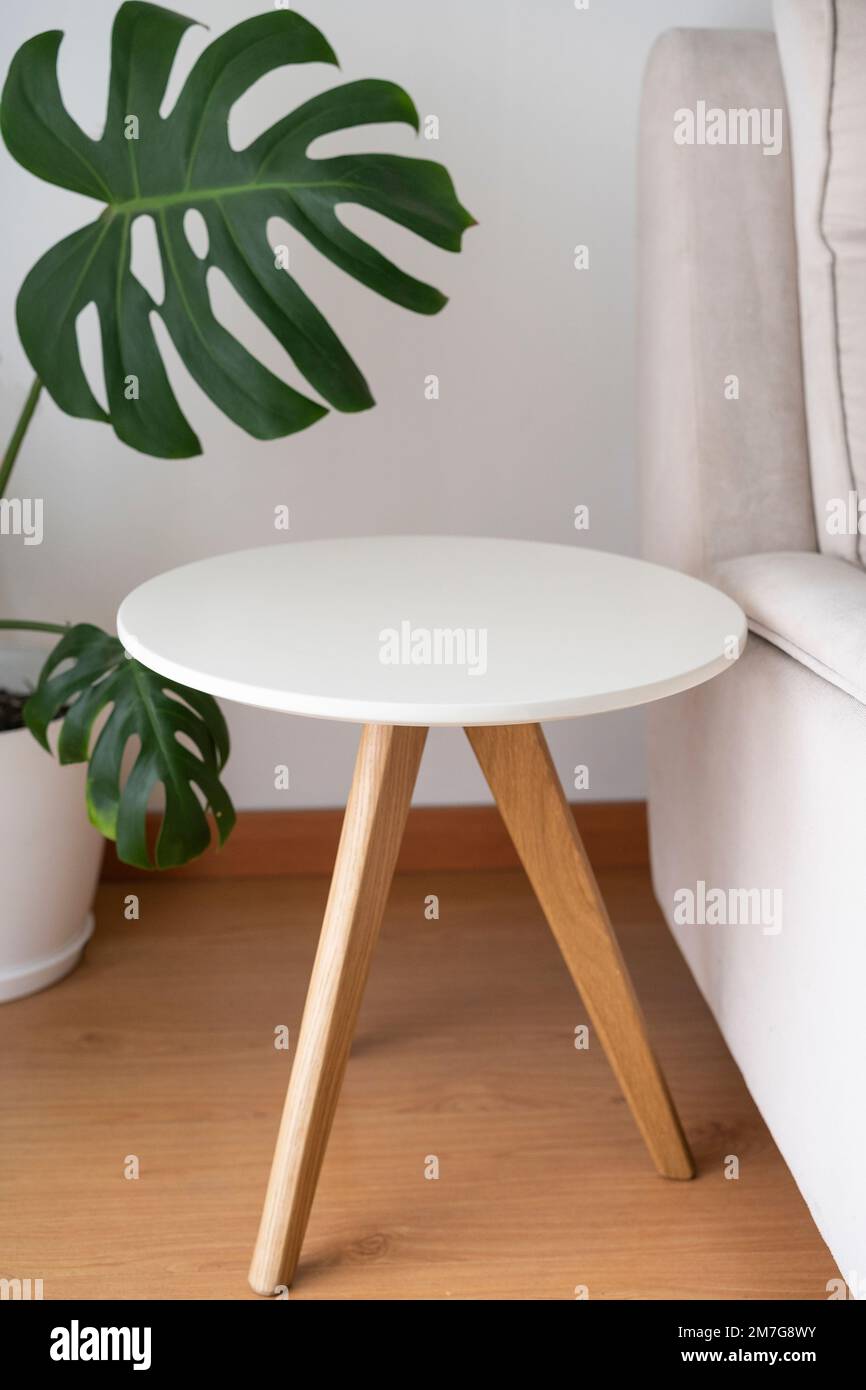 Round coffee table isolated near the couch Stock Photo Alamy