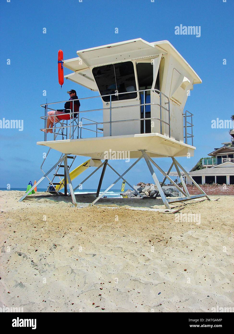 A lifeguard sitting in his lifeguard tower in Encinitas Beach Stock