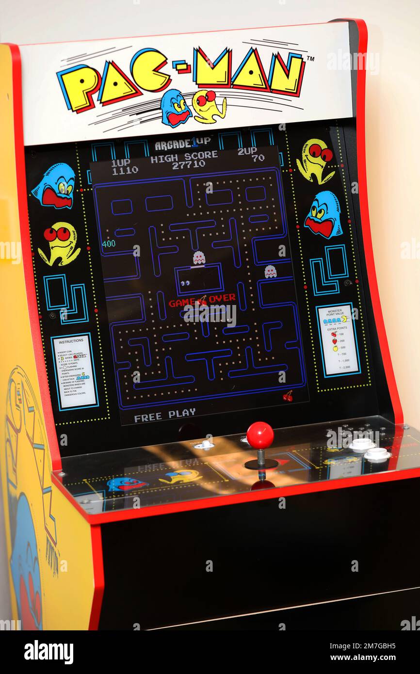 A vintage Pac-Man arcade machine in a games cafe in Havant, Hampshire, UK. Stock Photo