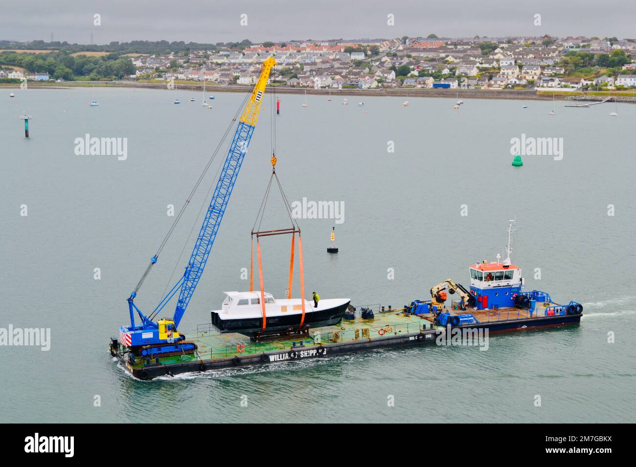 A boat being transported on a barge Stock Photo Alamy
