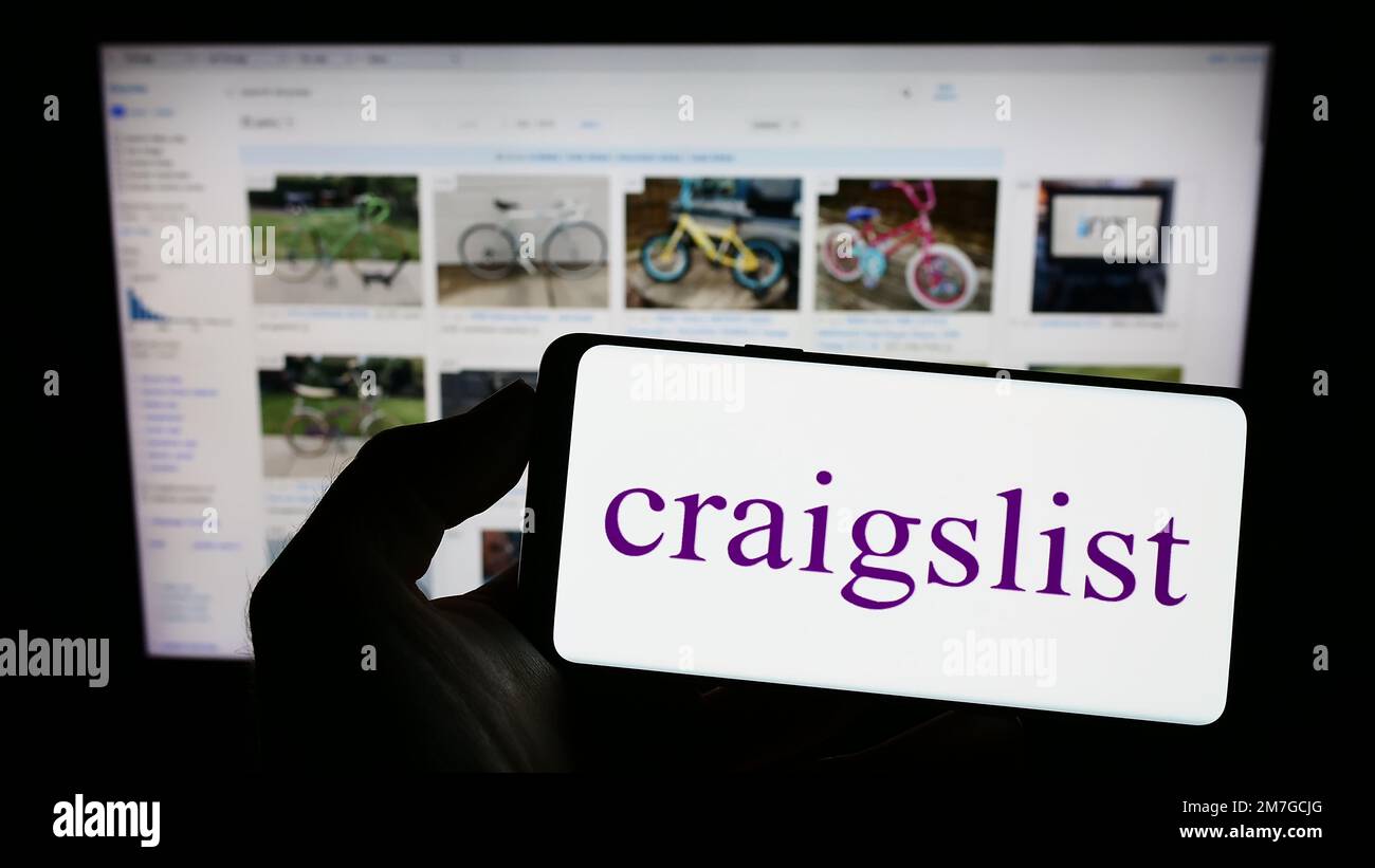 https://c8.alamy.com/comp/2M7GCJG/person-holding-cellphone-with-logo-of-classified-advertisements-company-craigslist-inc-on-screen-in-front-of-webpage-focus-on-phone-display-2M7GCJG.jpg