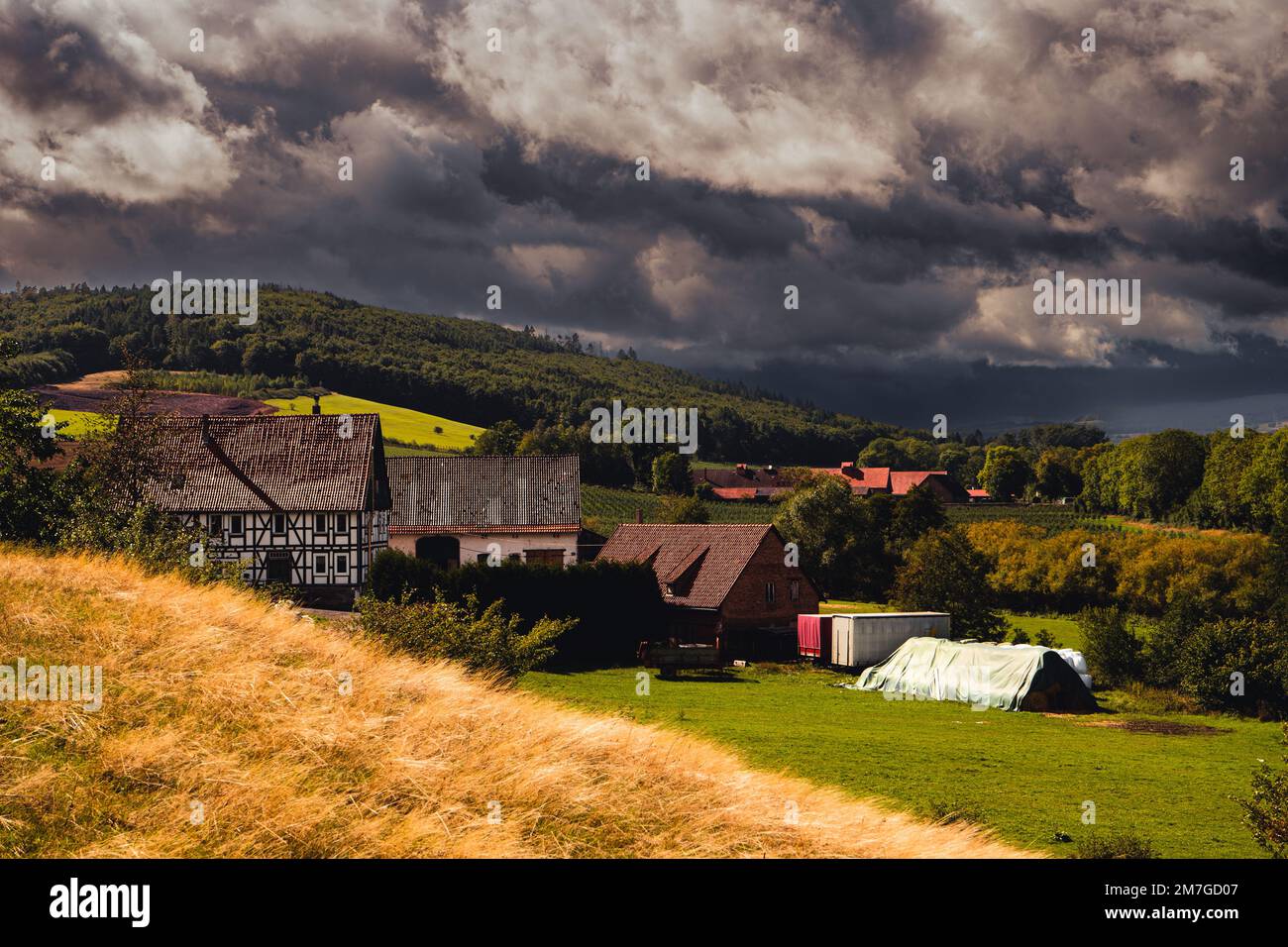 Orpethal, a village in the Rothaar Mountains with an approaching thunderstorm Stock Photo