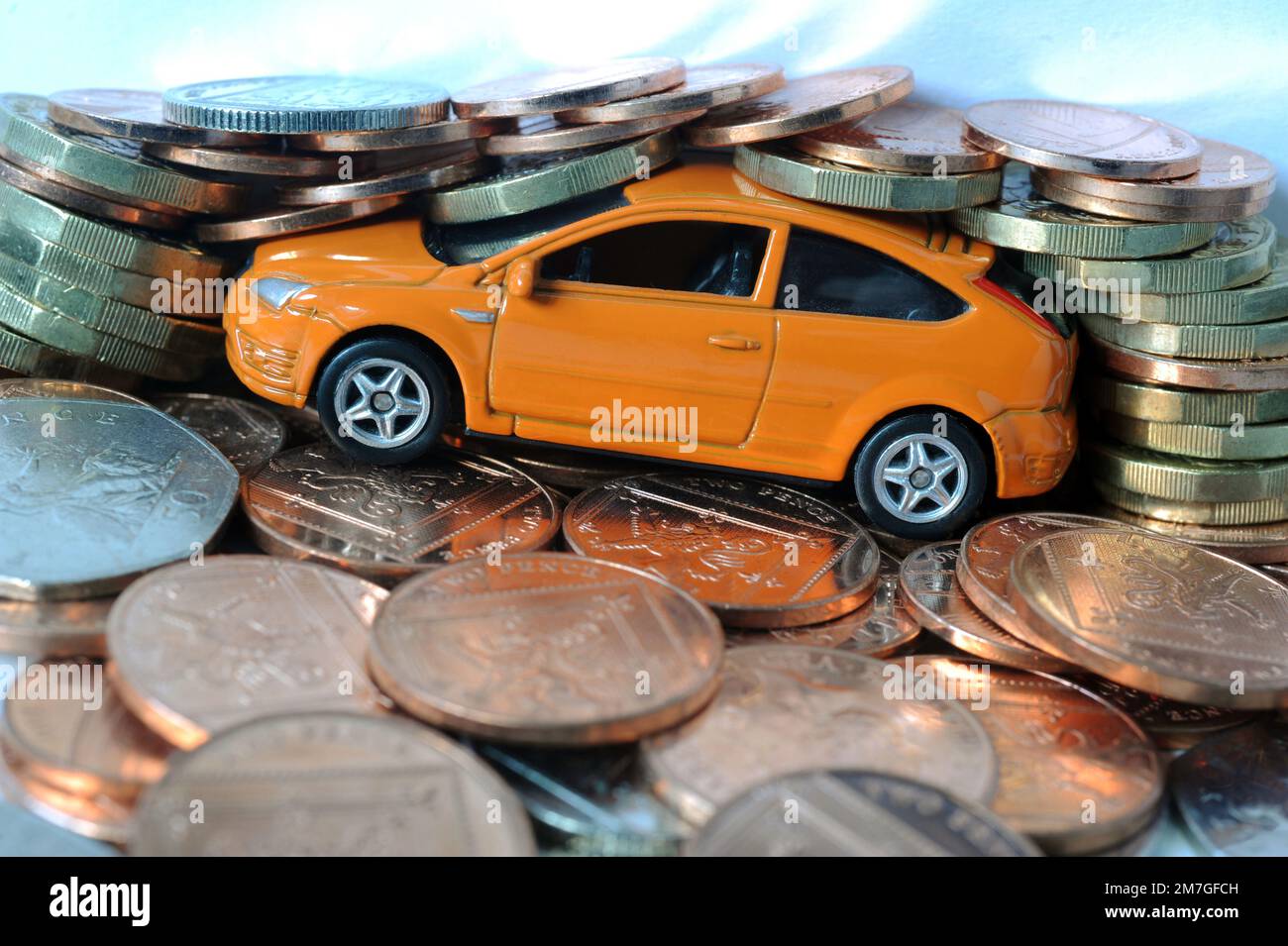 MODEL CAR WITH BRITISH MONEY RE CAR COSTS REPAIRS USED CAR PRICES DRIVERS TAX PETROL DIESEL ETC UK Stock Photo
