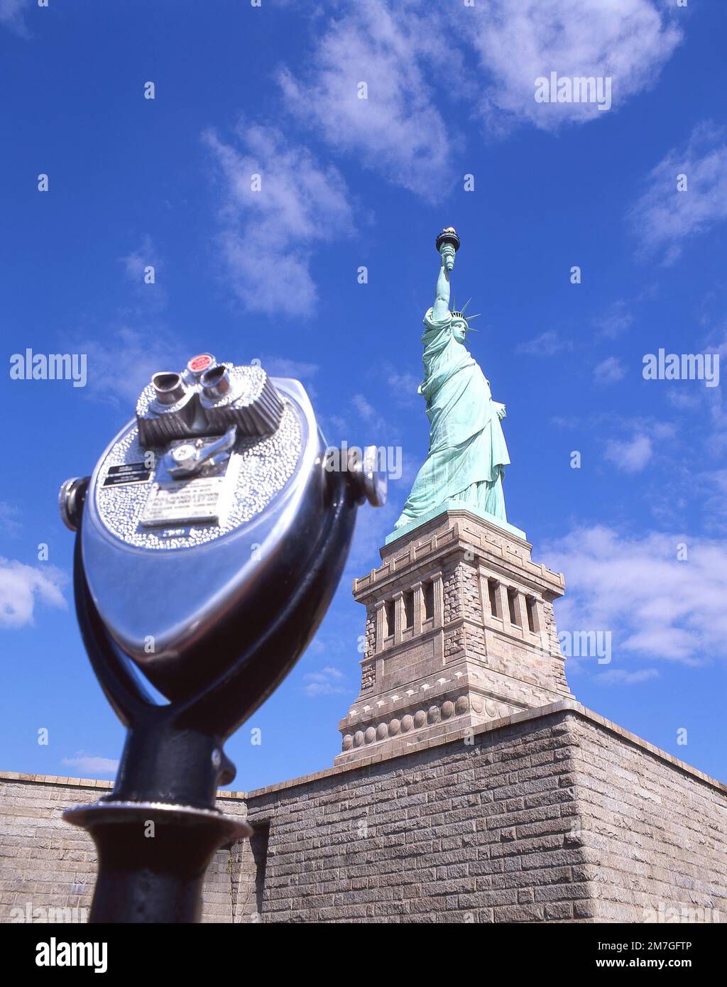Tower Optical coin-operated binocular and Statue of Liberty National Monument, Liberty Island, New York, New York State, United States of America Stock Photo
