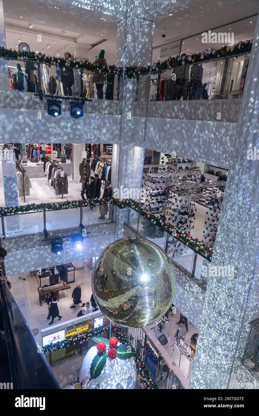 LONDON, UK - December 5, 2022: Selfridges on Oxford Street. Shop decorated for Christmas. Golden disco balls, escalators. Stock Photo