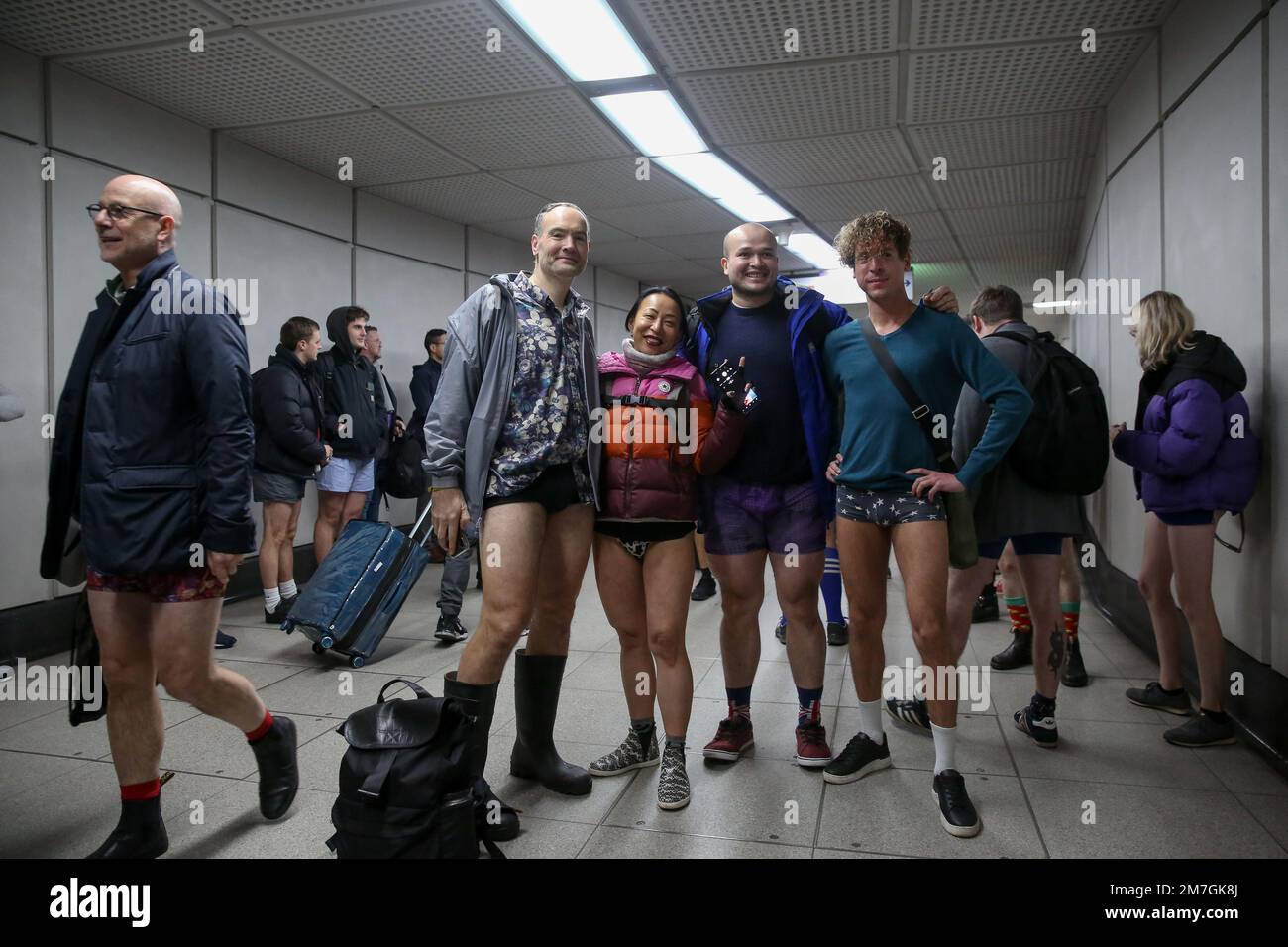 London UK 08th Jan 2023 Participants with no trousers wait for a train  in central London Over 100 participants took part in the annual No Trousers  Tube Ride event in central London