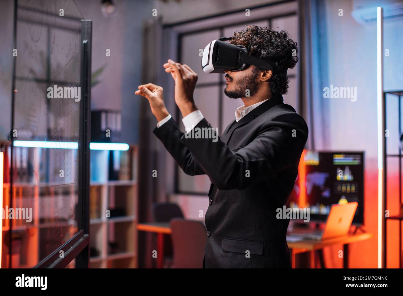 Vr Prom Young male company workers wearing VR headset while having meeting at ...