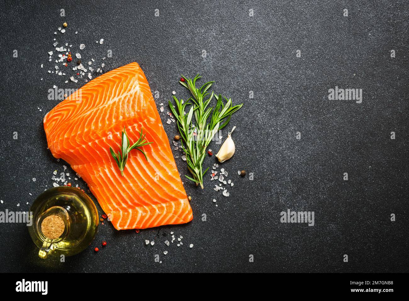 Raw salmon, fresh fish fillet at black background Stock Photo - Alamy