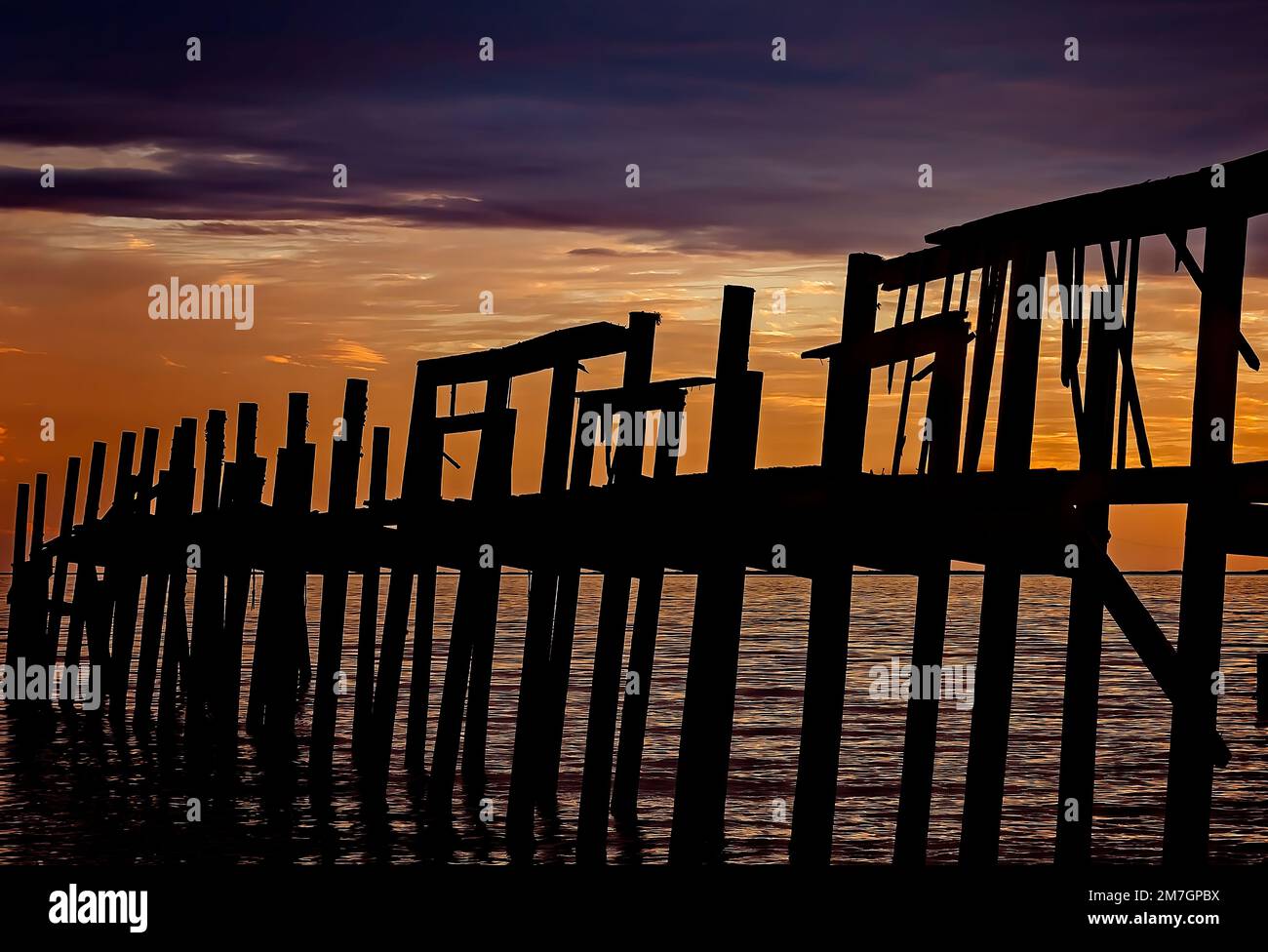 The sun sets on Bayou La Batre Beach, January 8, 2023, in Bayou La Batre, Alabama. The wharf was