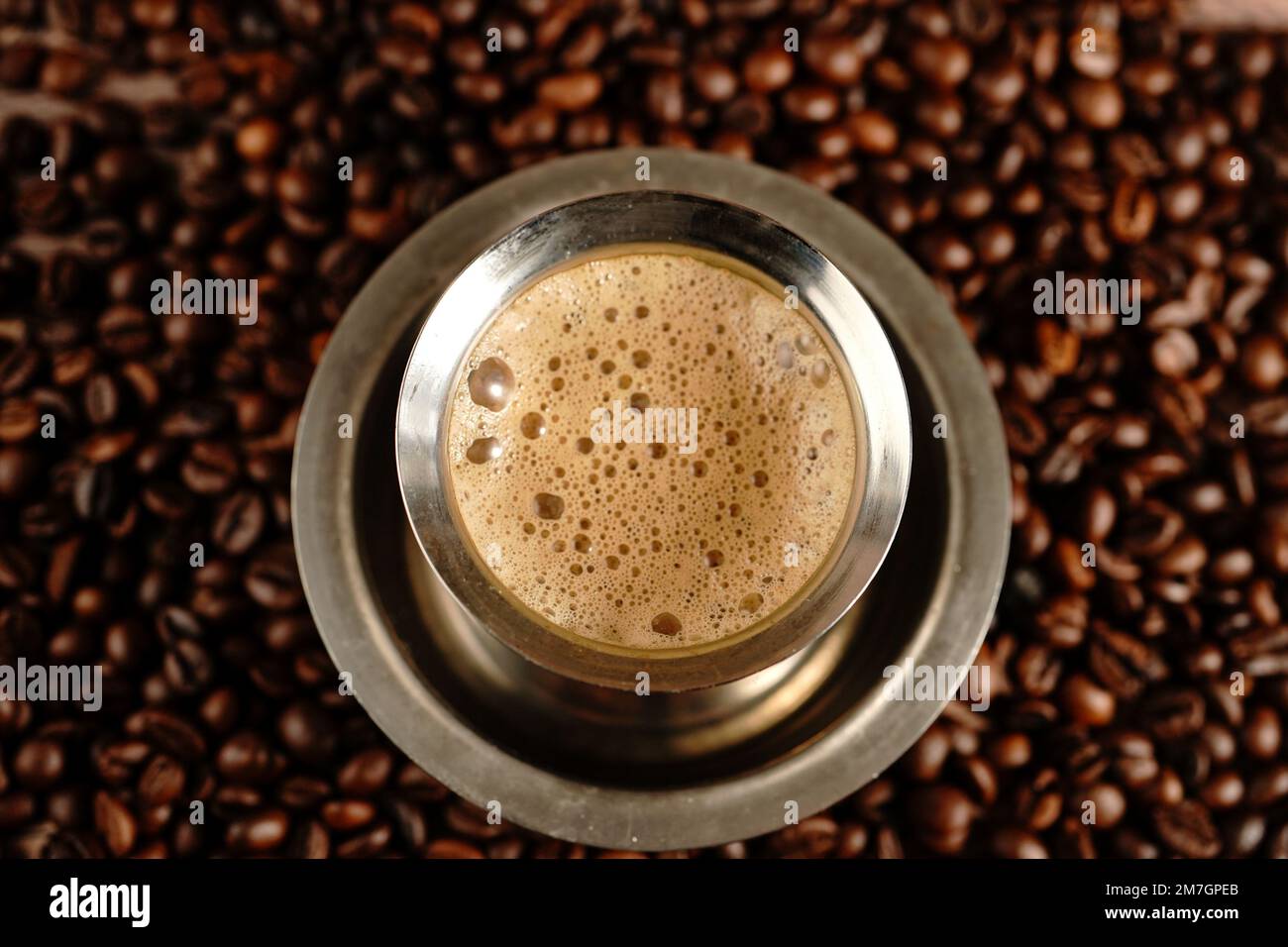 South Indian filter coffee served in steel cup and saucer, selective