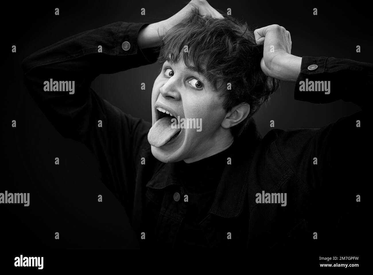 portrait of crazy young man showing the tongue. Stock Photo