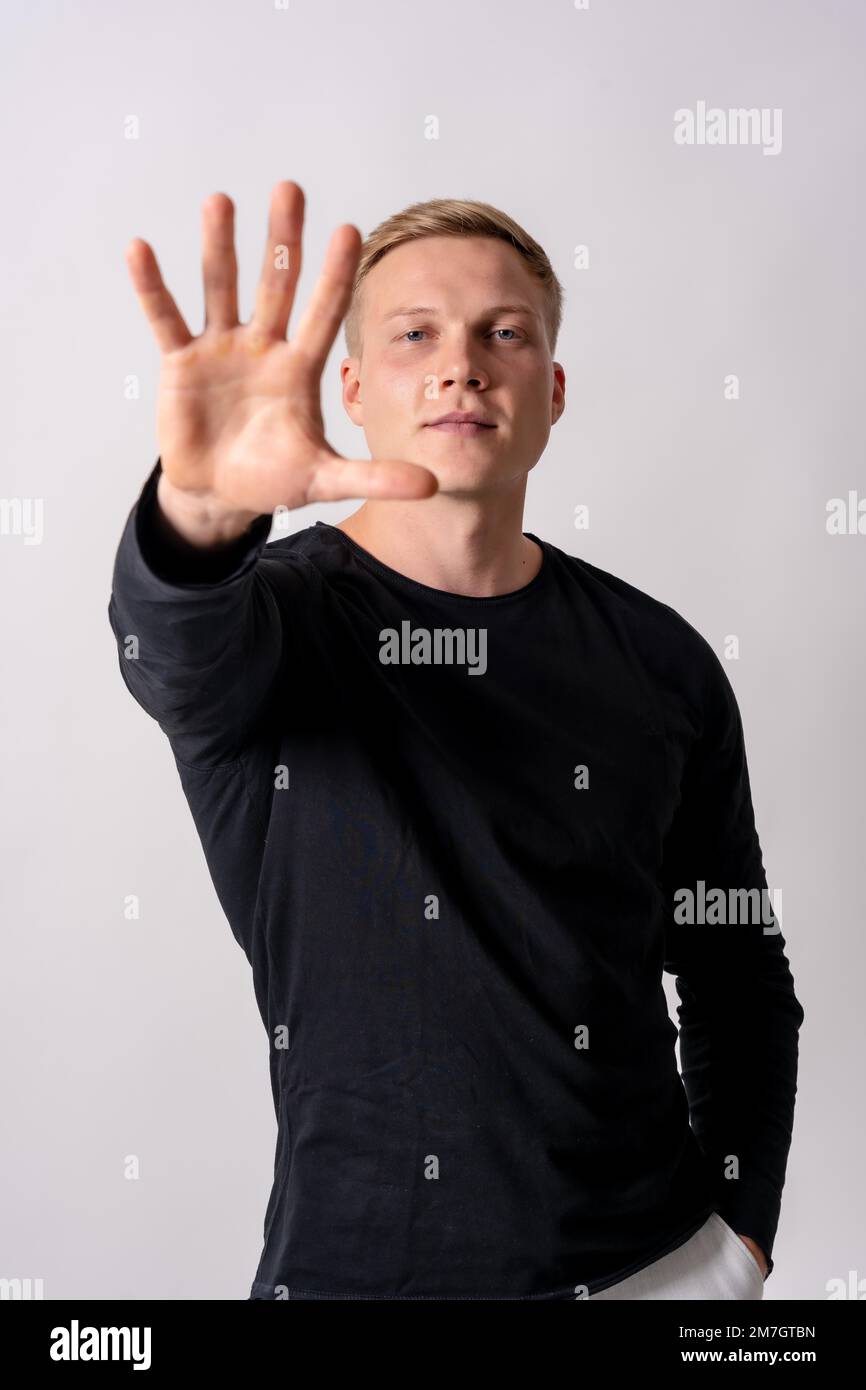 Attractive blonde german model in a black jersey on a white background, stop racism, stop homophobia Stock Photo
