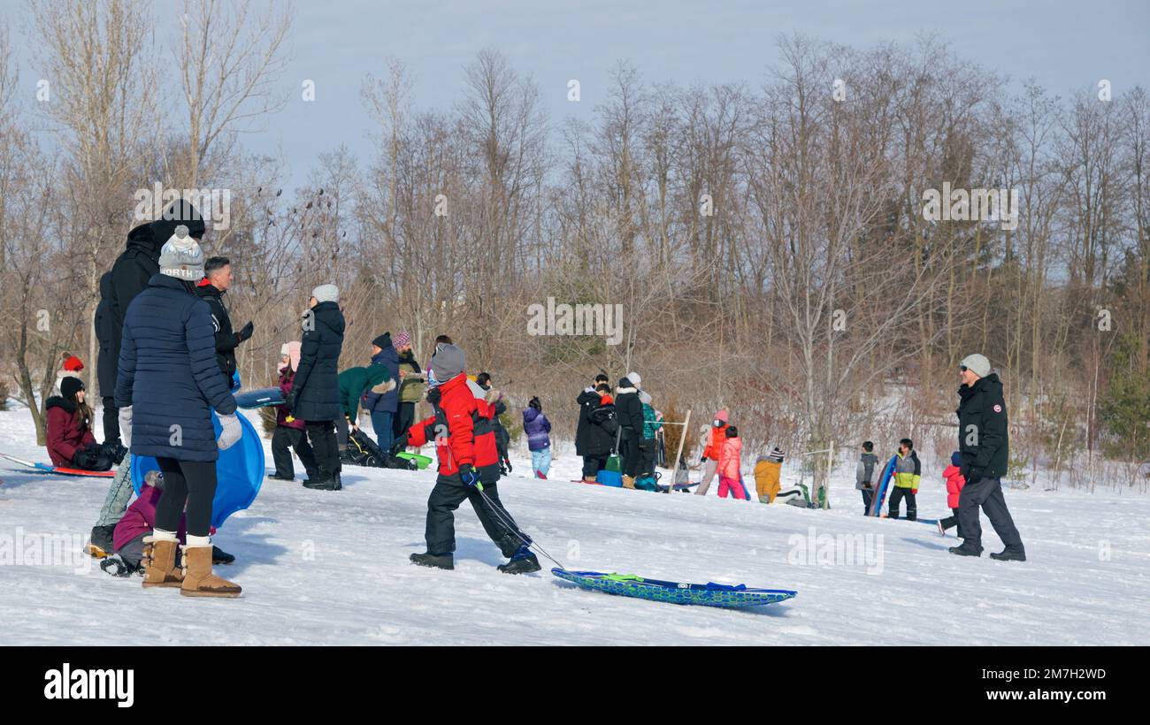 Toronto, Ontario / Canada 02212022 People playing toboggan in winter