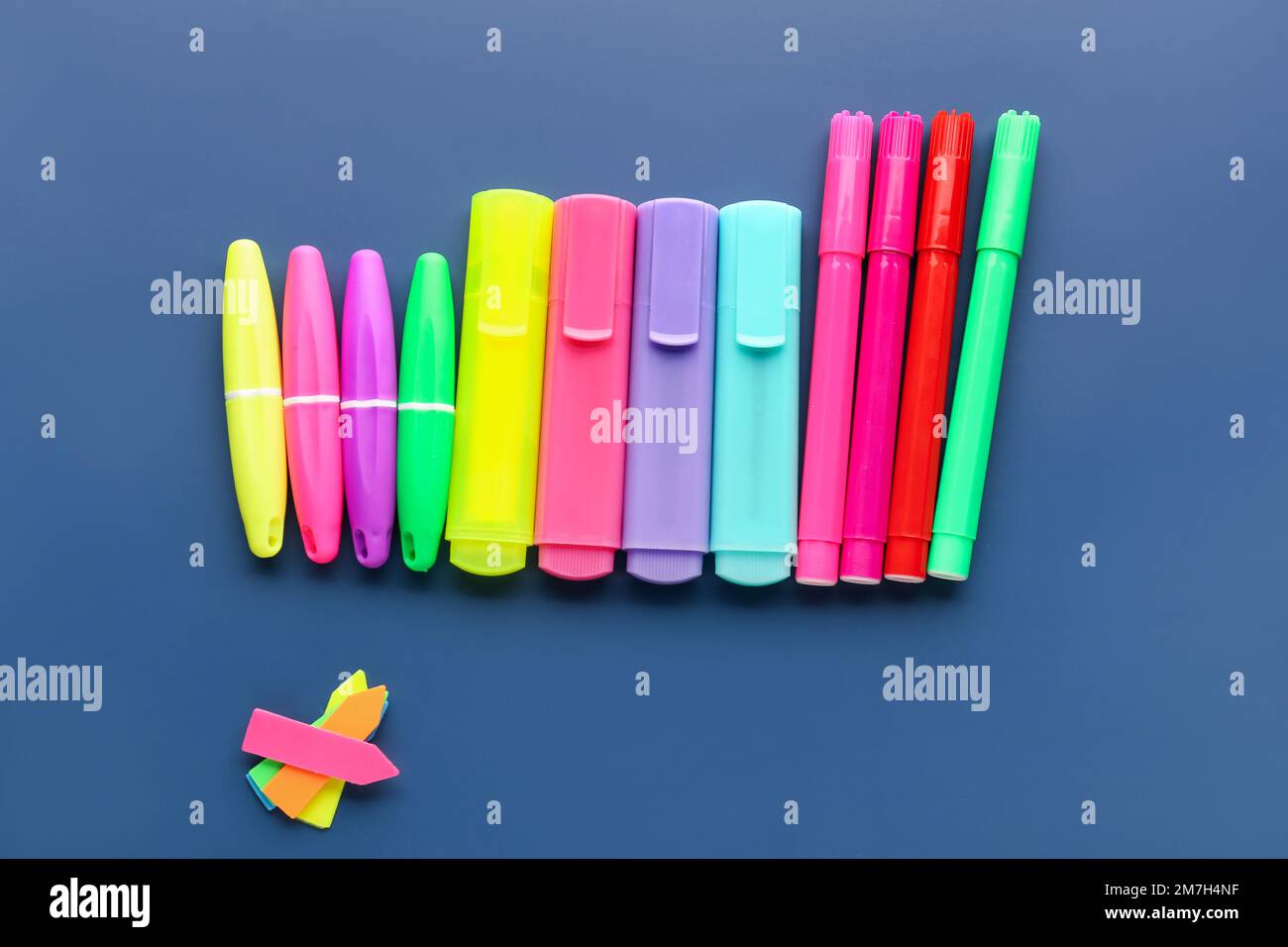 Set of different markers and sticky notes on color background Stock ...