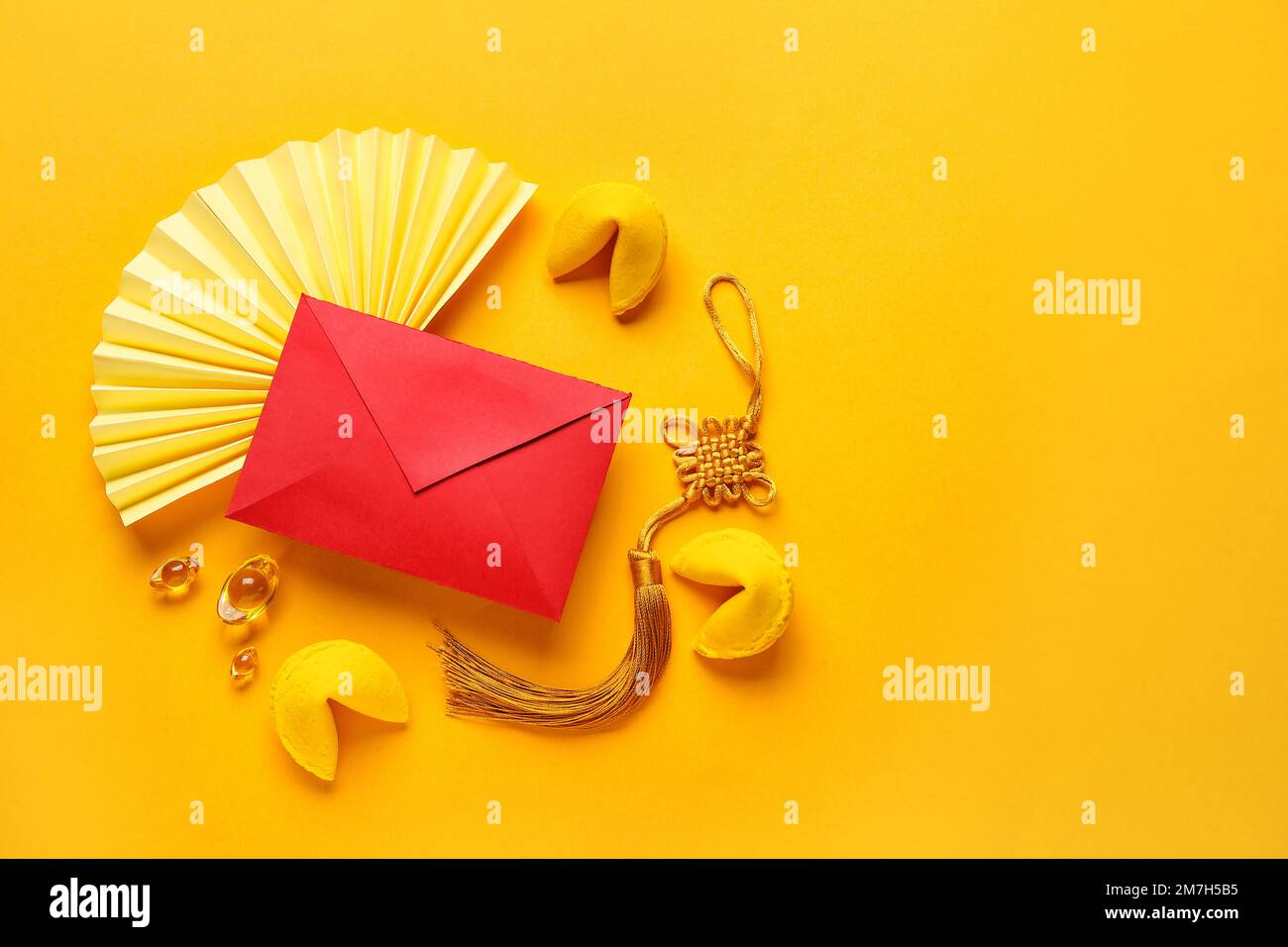Fortune cookies with red envelope and Chinese symbols on yellow ...