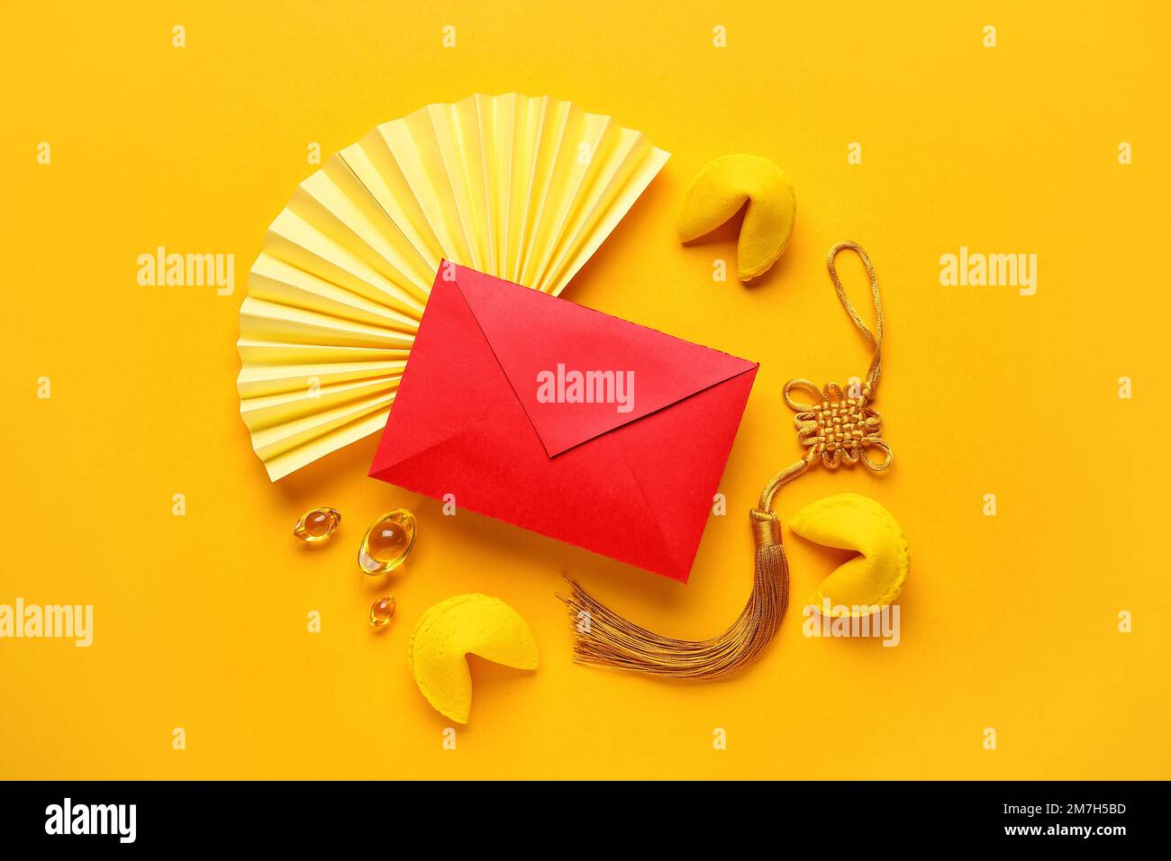 Fortune cookies with red envelope and Chinese symbols on yellow ...