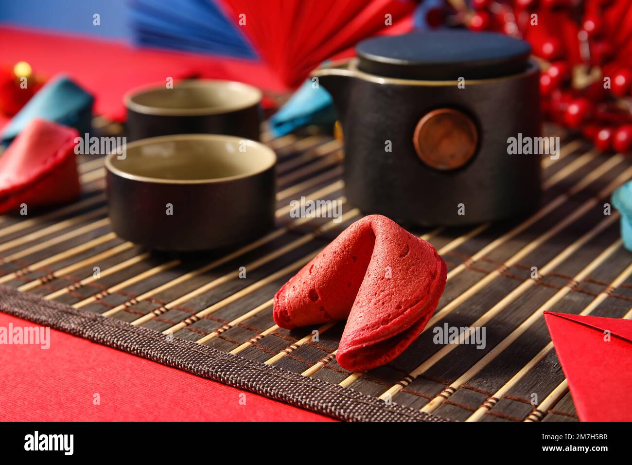Mat with fortune cookie on red table, closeup. Chinese New Year celebration  Stock Photo - Alamy