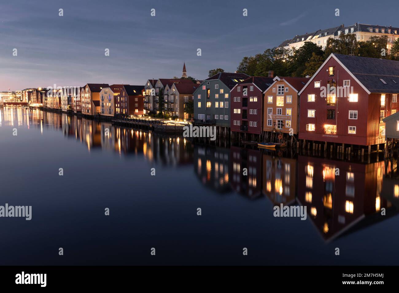 Colorful houses during blue hour along Nidelva River in Trondhei Stock Photo