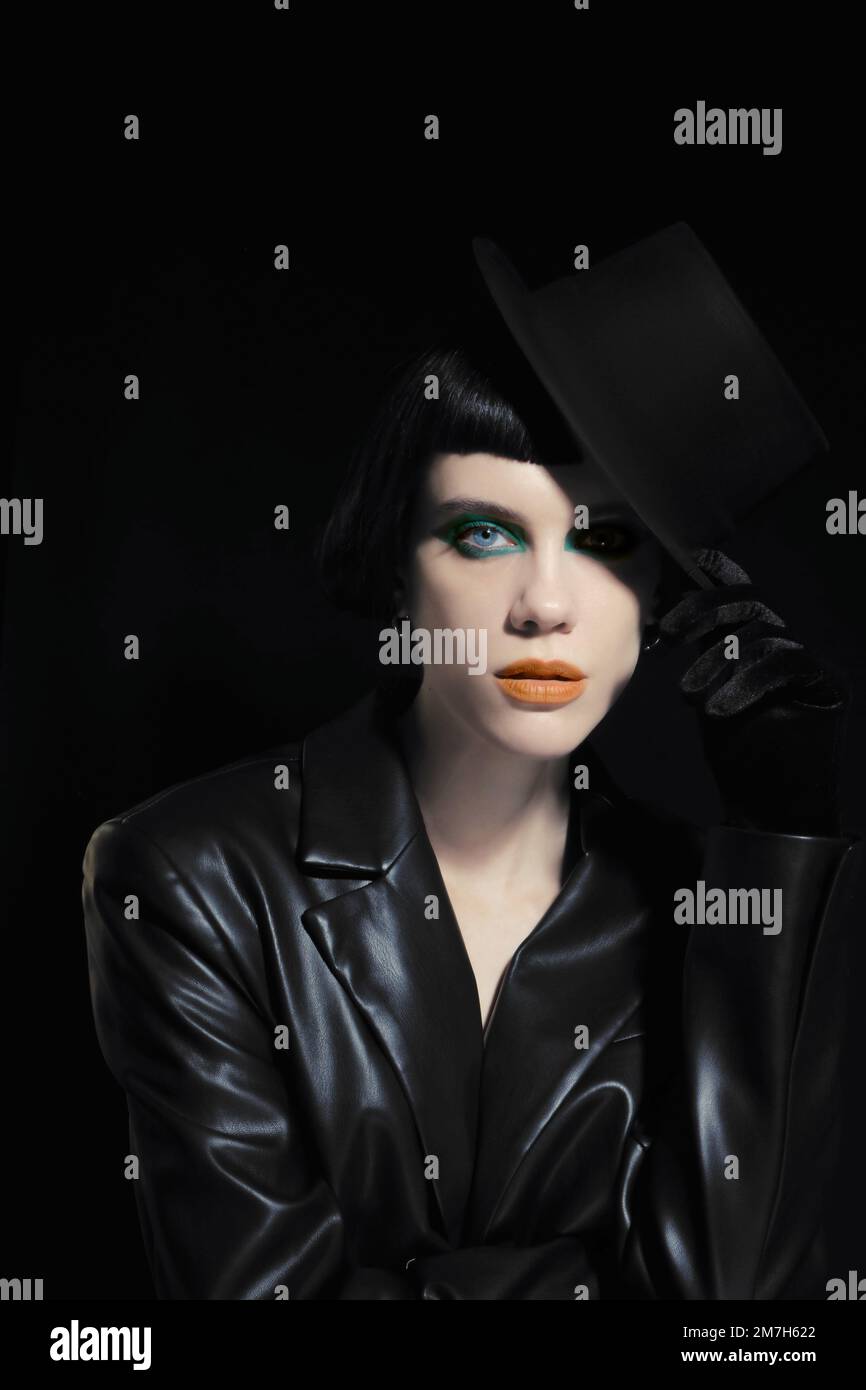 Artdeco makeup at young model with orange lips, green eyeshadows Stock