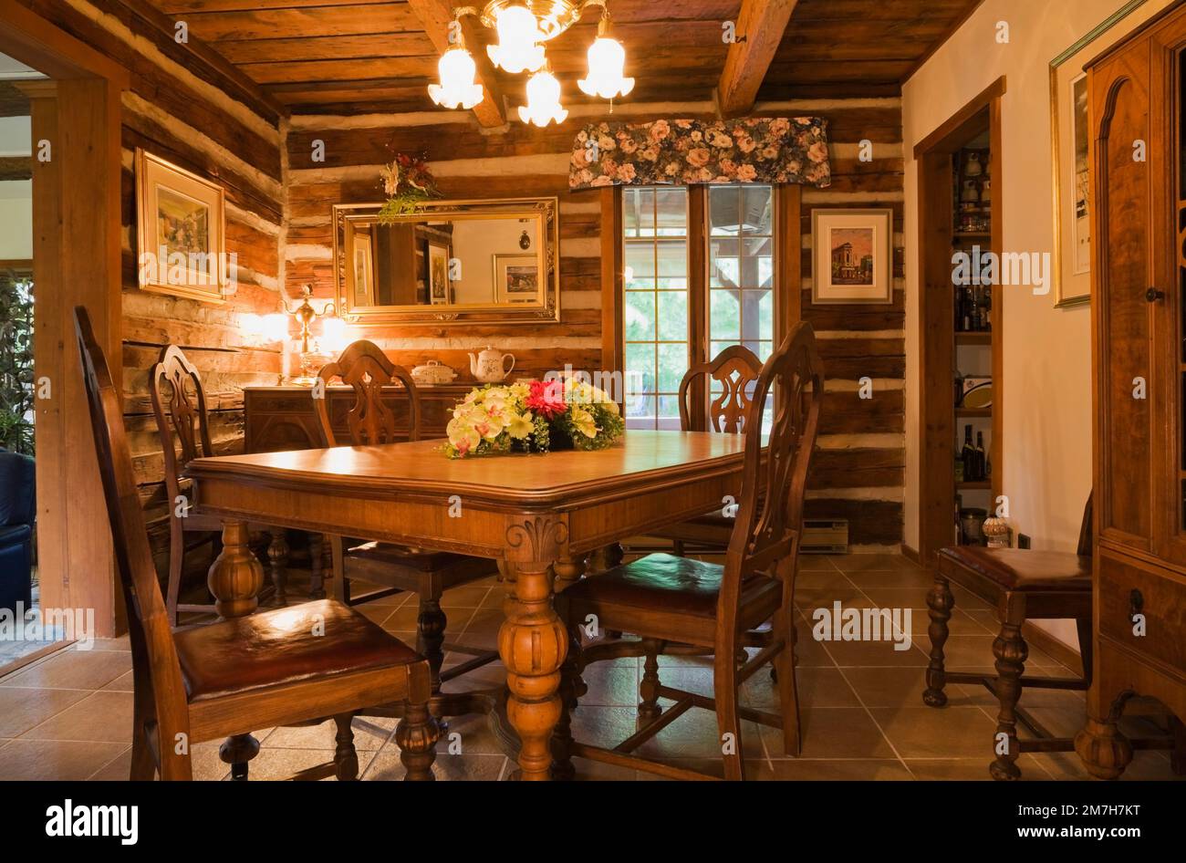 Old wooden dining table and chairs in dining room inside 1987 reconstructed  cottage style log home Stock Photo - Alamy, image size:1300x946