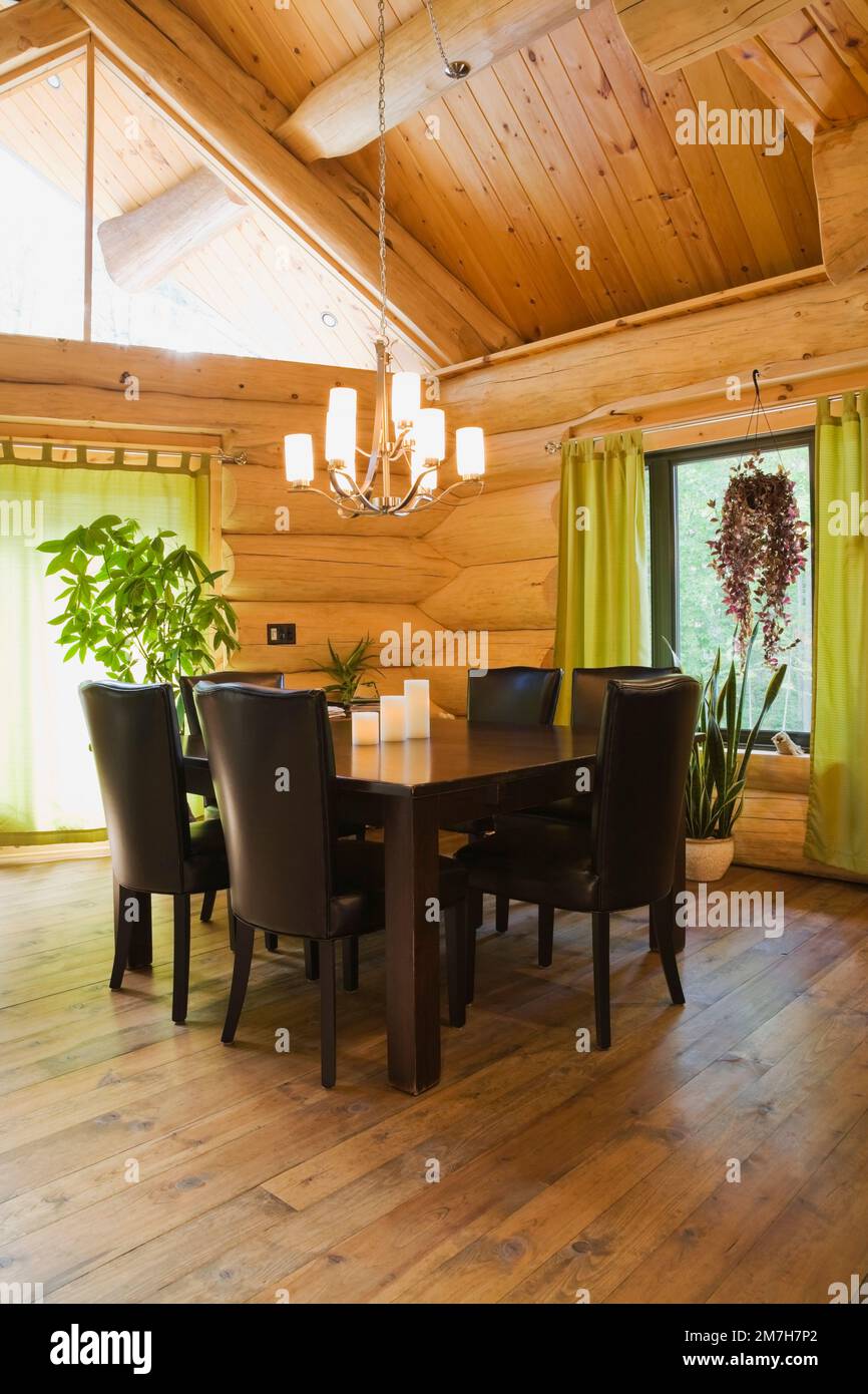 Brown stained pine wood dining table and brown leather high back chairs