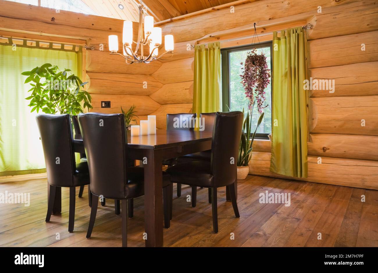 Brown stained pine wood dining table and brown leather highback