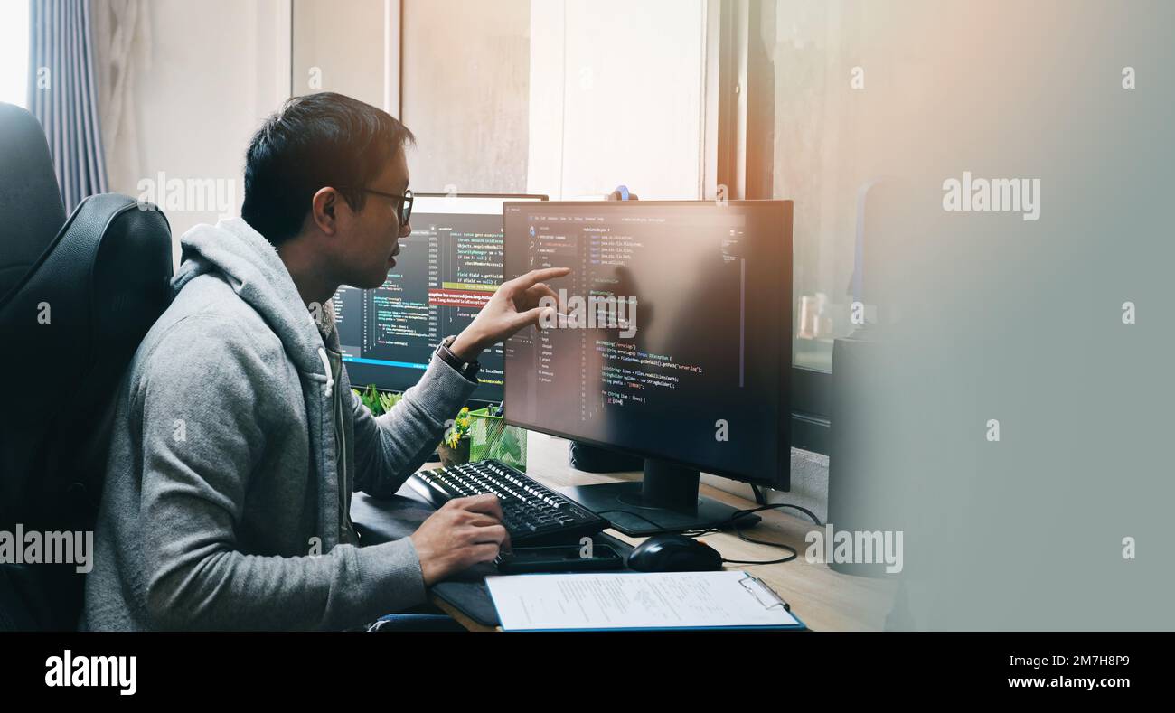 Coder programmers working in office, Programmer analyst writing code - Coder working from home with work on screen computer for learning and developin Stock Photo