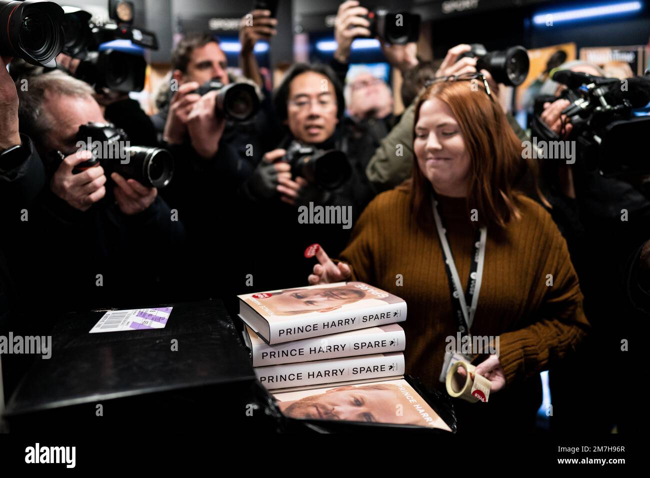 Members of the media take photos of the newly released autobiography from the Duke of Sussex at WHSmith's in Victoria Station, London, where the book became available to purchase at midnight. Picture date: Tuesday January 10, 2023. Stock Photo