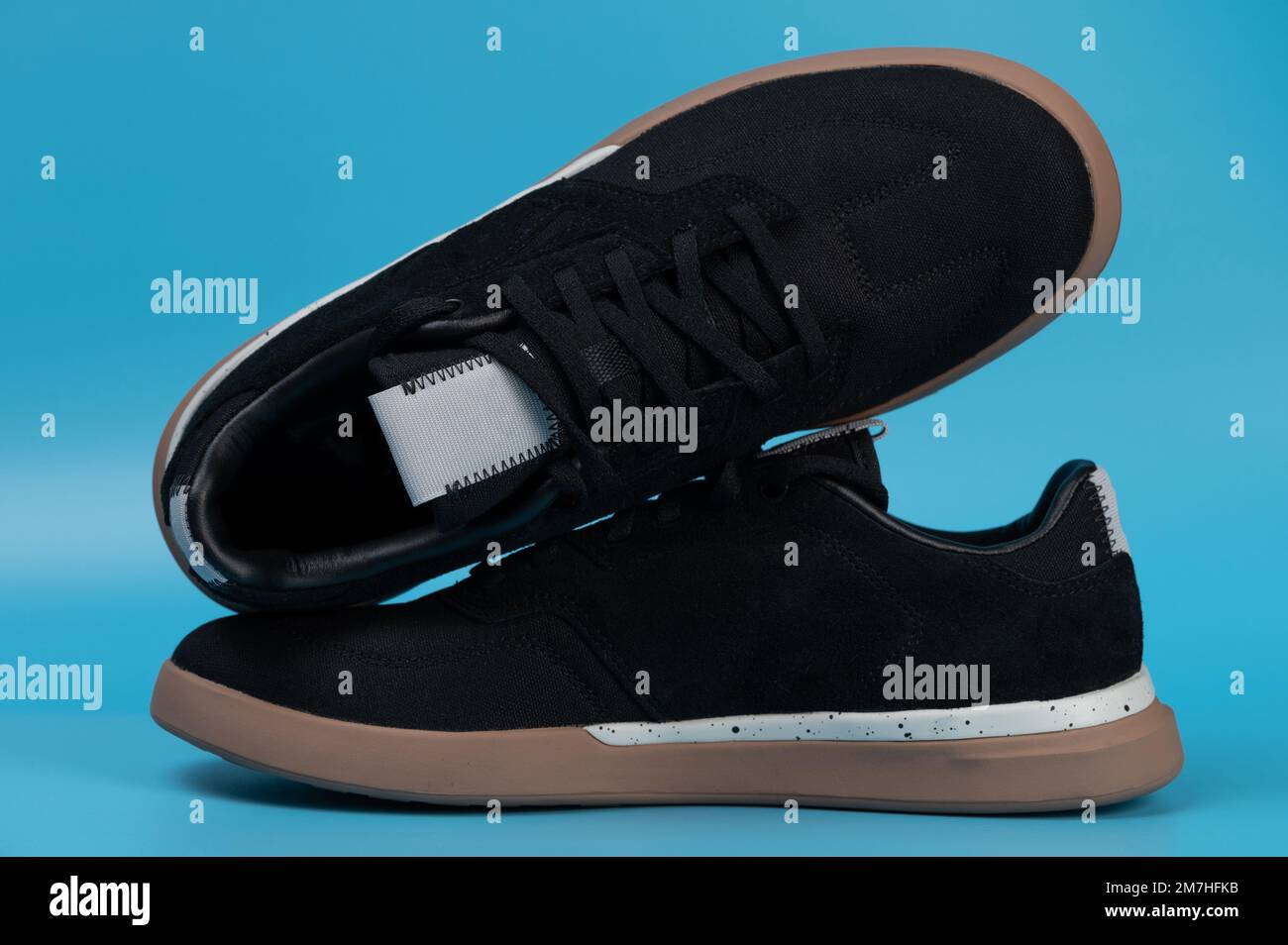 Pair of black casual shoes side and top view isolated on blue studio background Stock Photo
