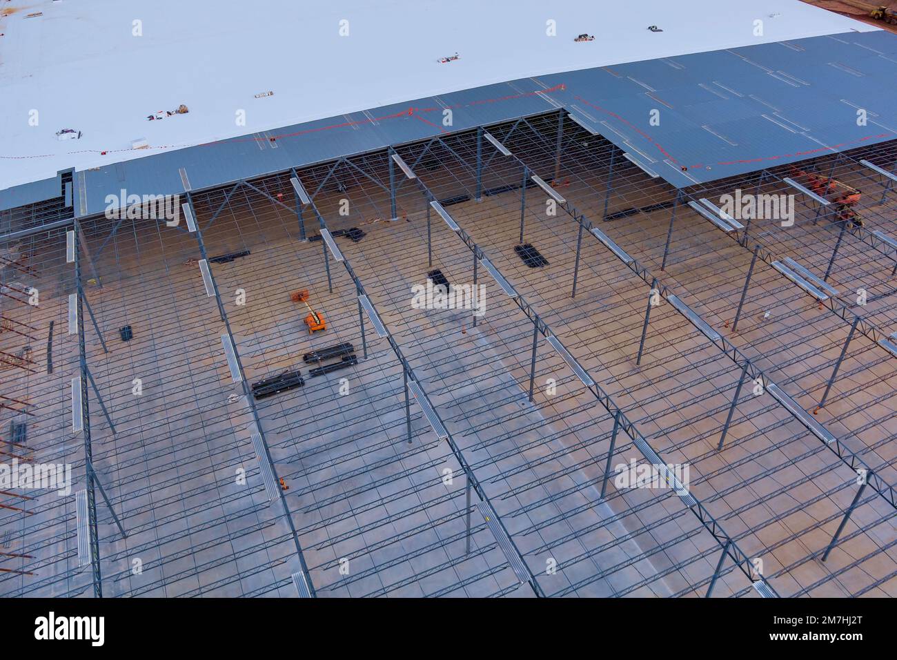 In building site of warehouse under construction metal frame steel framework is being used for roof trusses Stock Photo