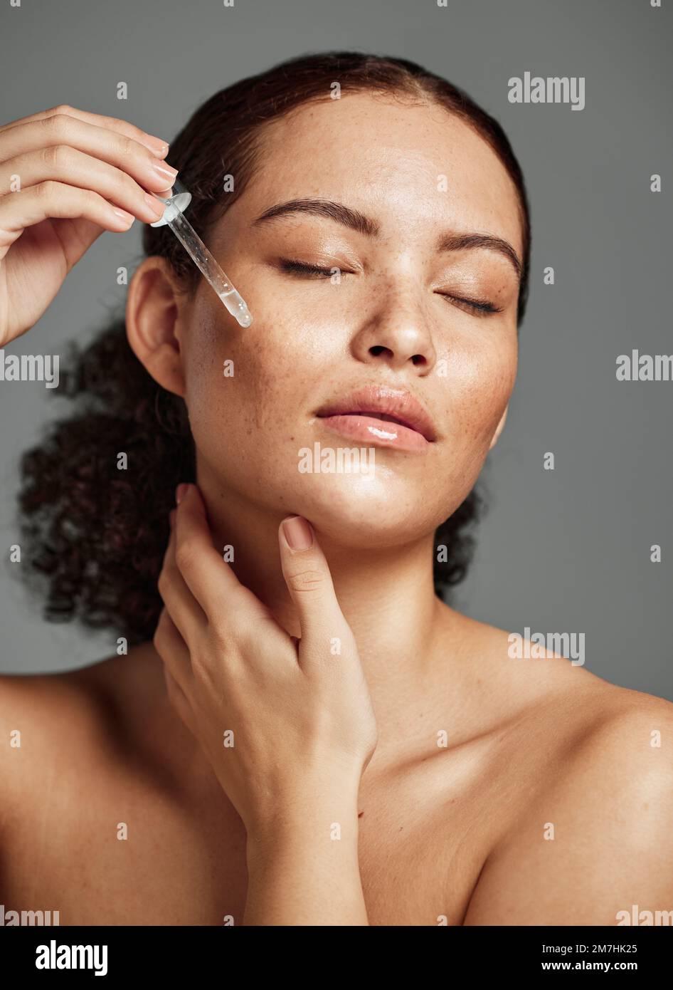 Beauty, skincare and serum with face of woman for facial, product or self care with morning routine. Luxury, health and wellness with girl model and Stock Photo