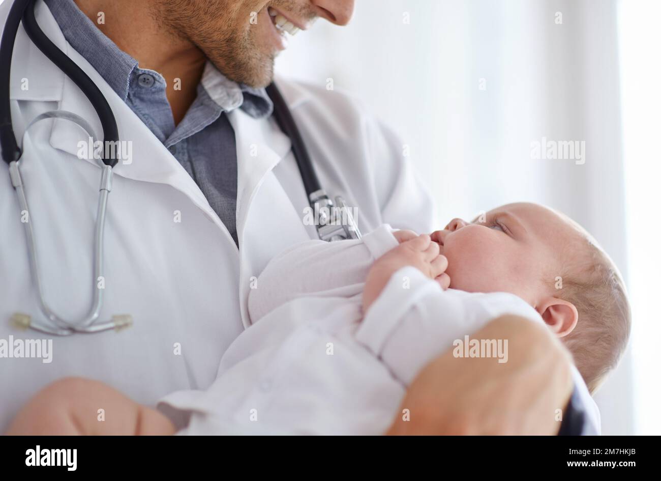 Precious little life. a handsome male doctor holding a baby. Stock Photo