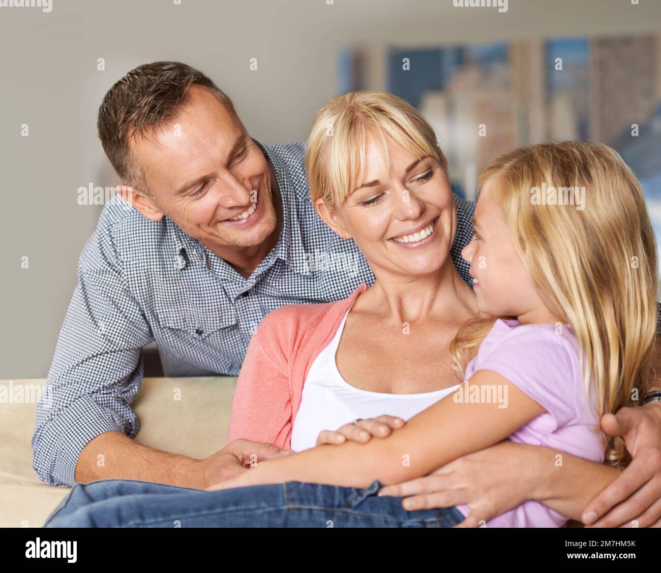 We make beautiful kids, dont we. a loving family embracing each other on the sofa. Stock Photo