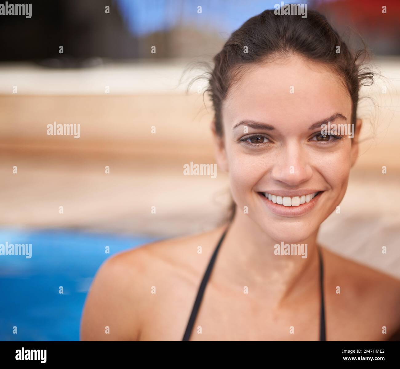 Pretty in the pool. Portrait of an attractive young woman smiling in the pool. Stock Photo
