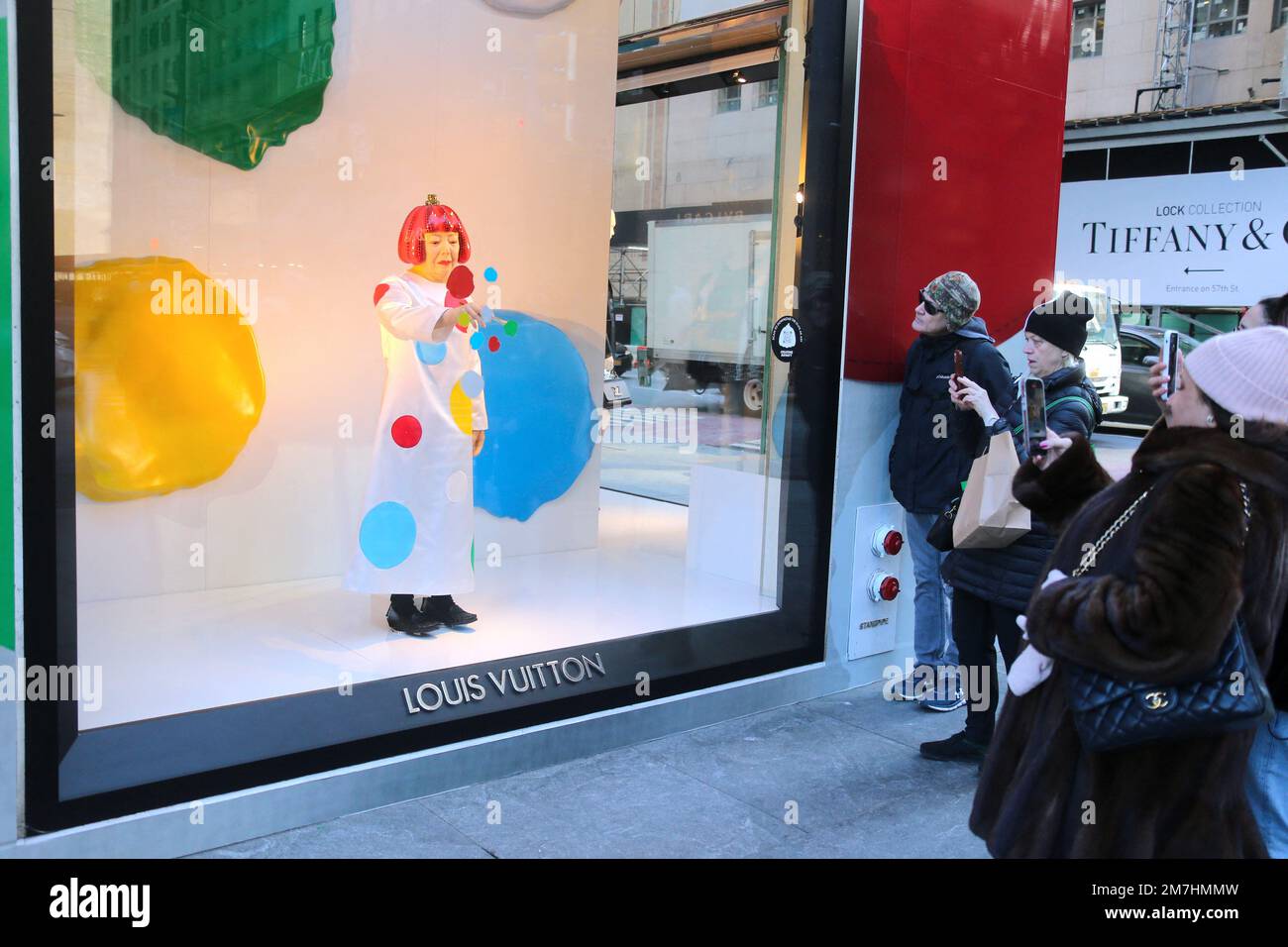 New York, USA. 09th Jan, 2023. Japanese artist Yayoi Kusama robot painting  her famous spots in the window at the Louis Vuitton Fifth Avenue store in  New York City, NY, USA on