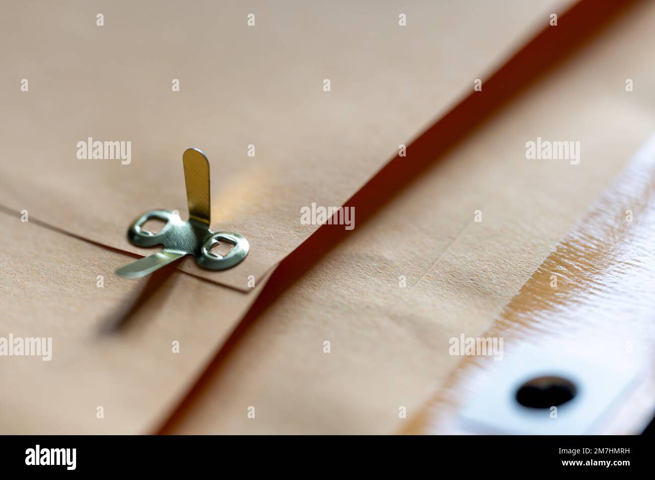 manilla envelope with reinforced hole and metal folding clasp Stock