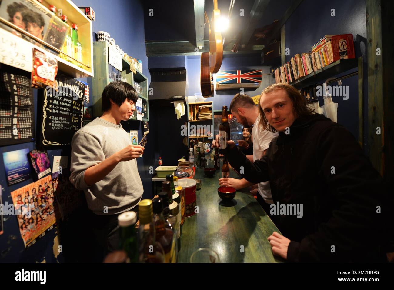 Drinking in a small atmospheric pub in the Golden Gai pub area in Shinjuku, Tokyo, Japan. Stock Photo