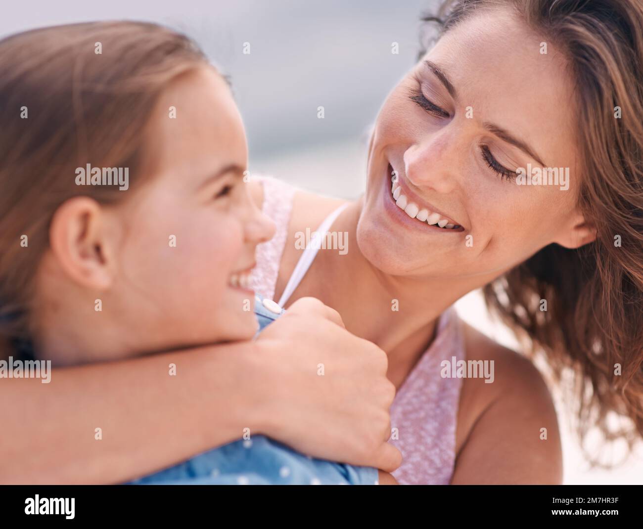 I Cherish Her A Young Mother Embracing Her Daughter At The Beach Stock