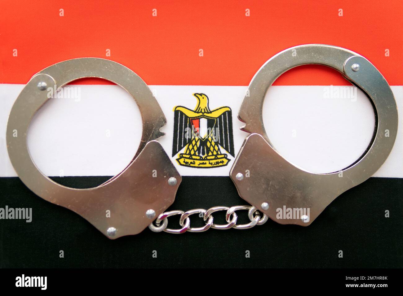 Egypt flag and police handcuffs. The concept of crime and offenses in the country. the concept of crime in the state or government of the country. Stock Photo