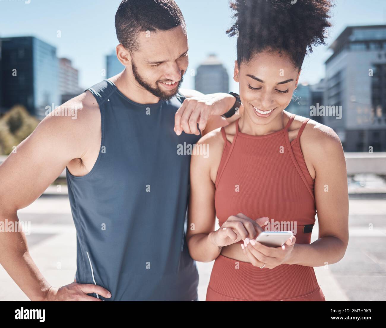 Fitness, workout and black couple with phone in city for running, marathon training and workout. Love, sports and man and woman on smartphone for Stock Photo