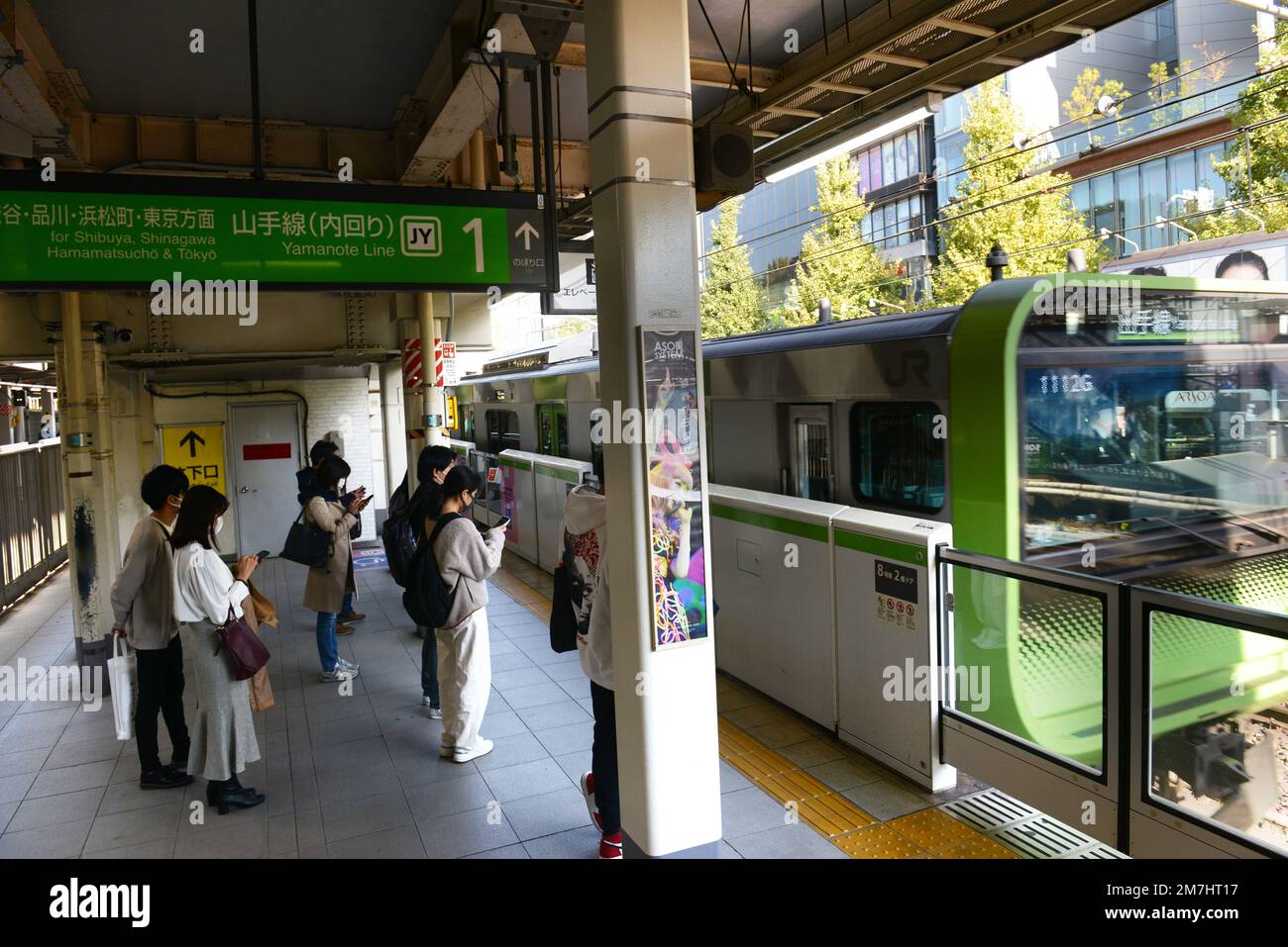 Japanese passengers waiting for the JR Yamanote line in Tokyo, Japan