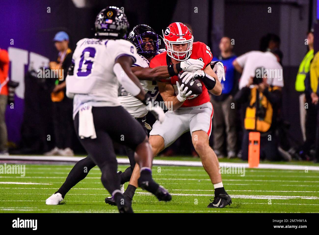 FILE - Georgia tight end Brock Bowers (19) makes a touchdown catch over TCU  safety Abraham Camara (14) during the second half of the national  championship NCAA College Football Playoff game, Monday