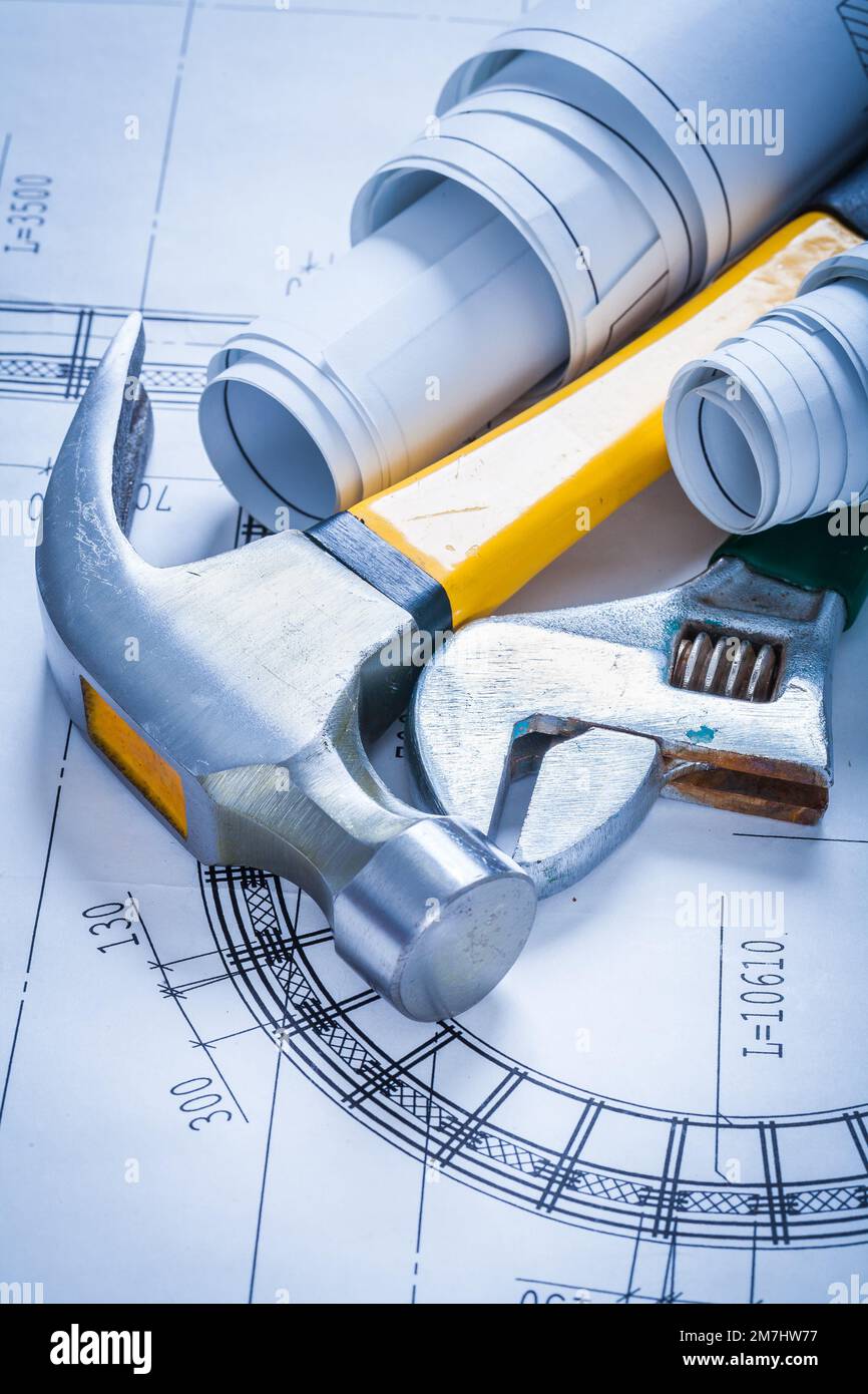 Adjustable spanner rolled up blueprints and claw hammer maintenance