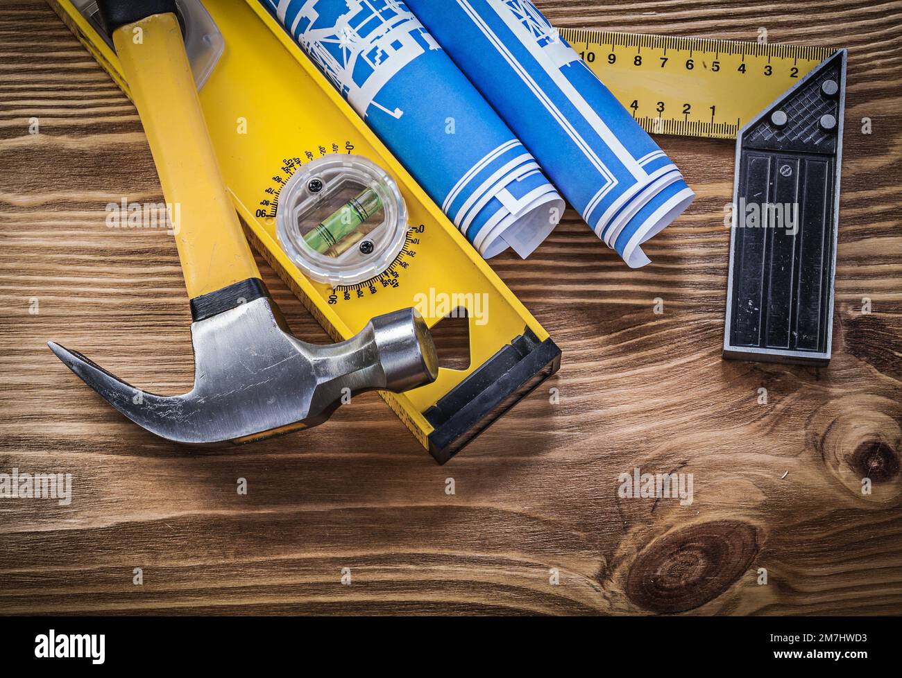 Blue blueprints construction level try square claw hammer on wooden ...
