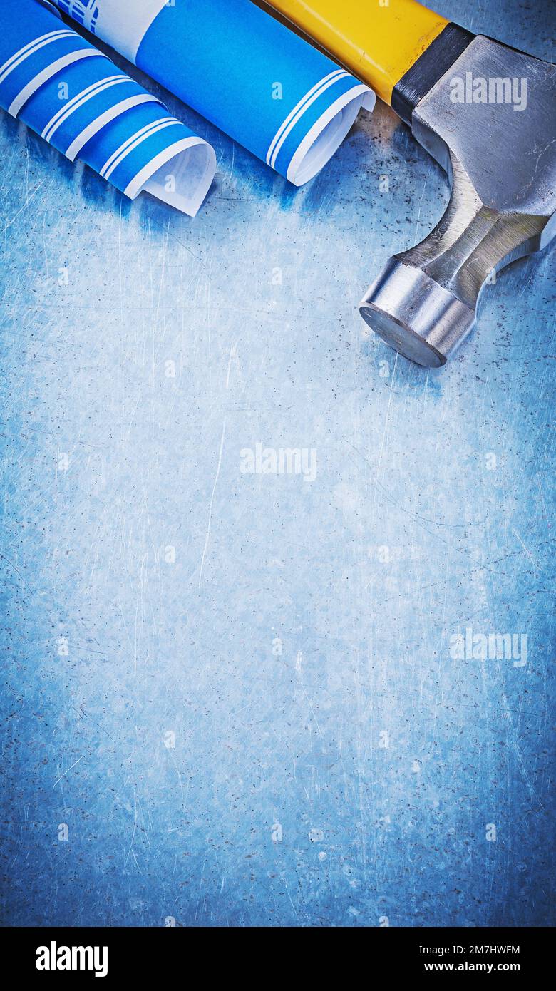 Blue construction drawings claw hammer on metallic background copy ...