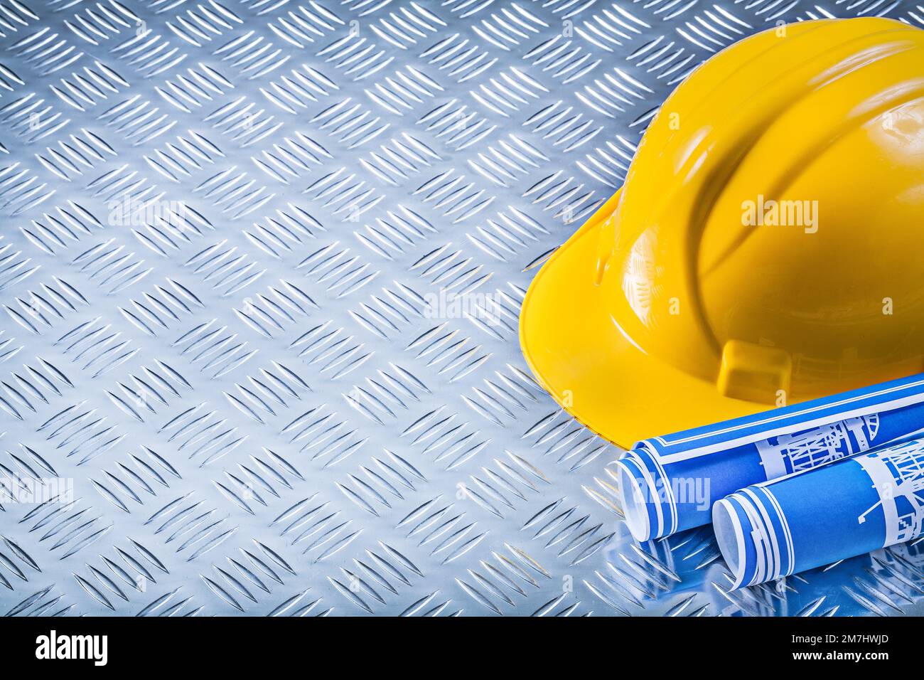Blue engineering drawings building helmet on channeled metal plate ...