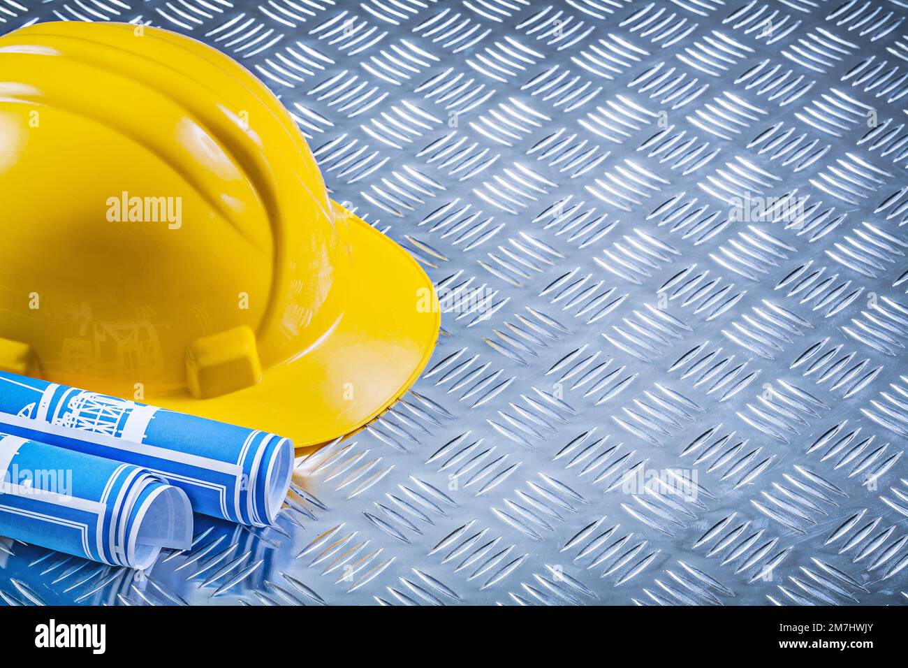 Blue engineering drawings building helmet on corrugated metal ...